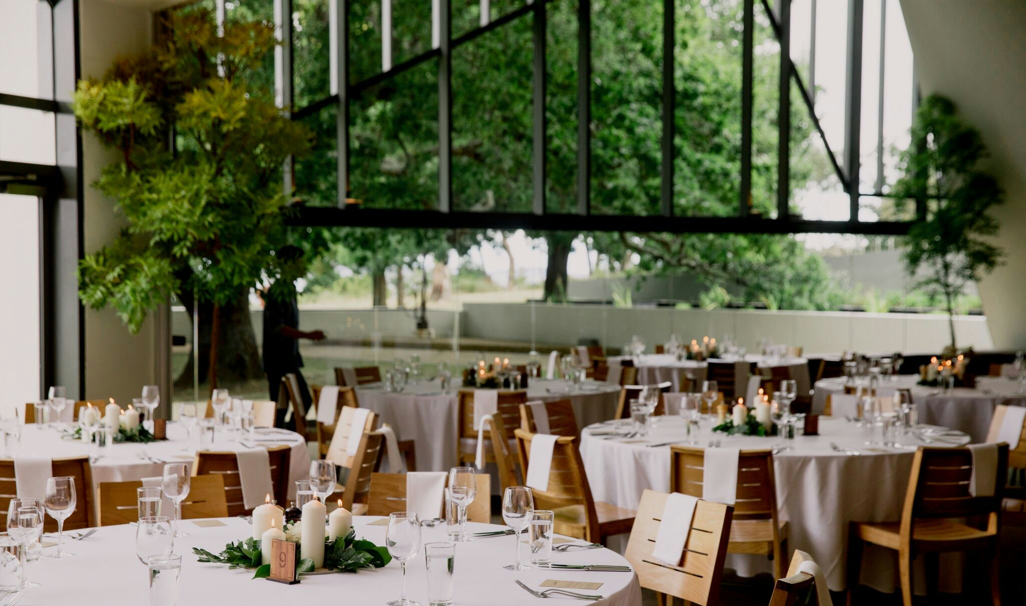 Wedding tables setup with a green garden outlook.